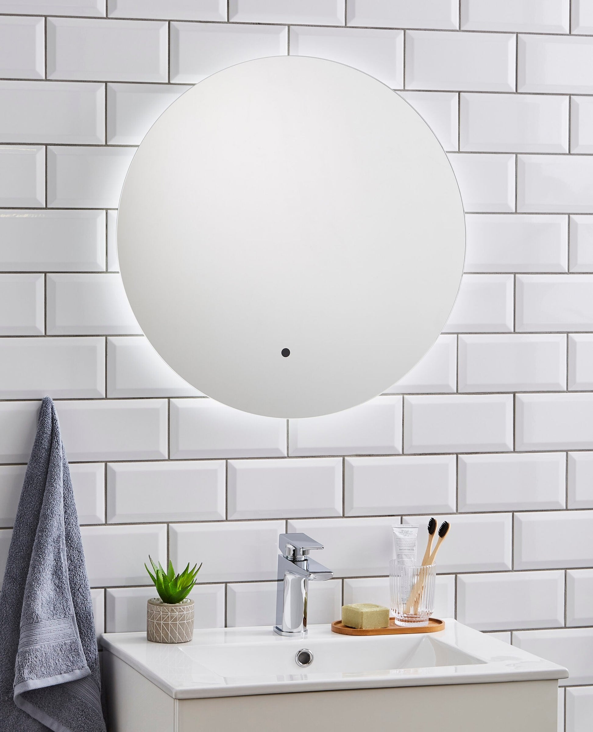 K-VIT Tucson 600mm Circular LED Mirror mounted on white tiles
