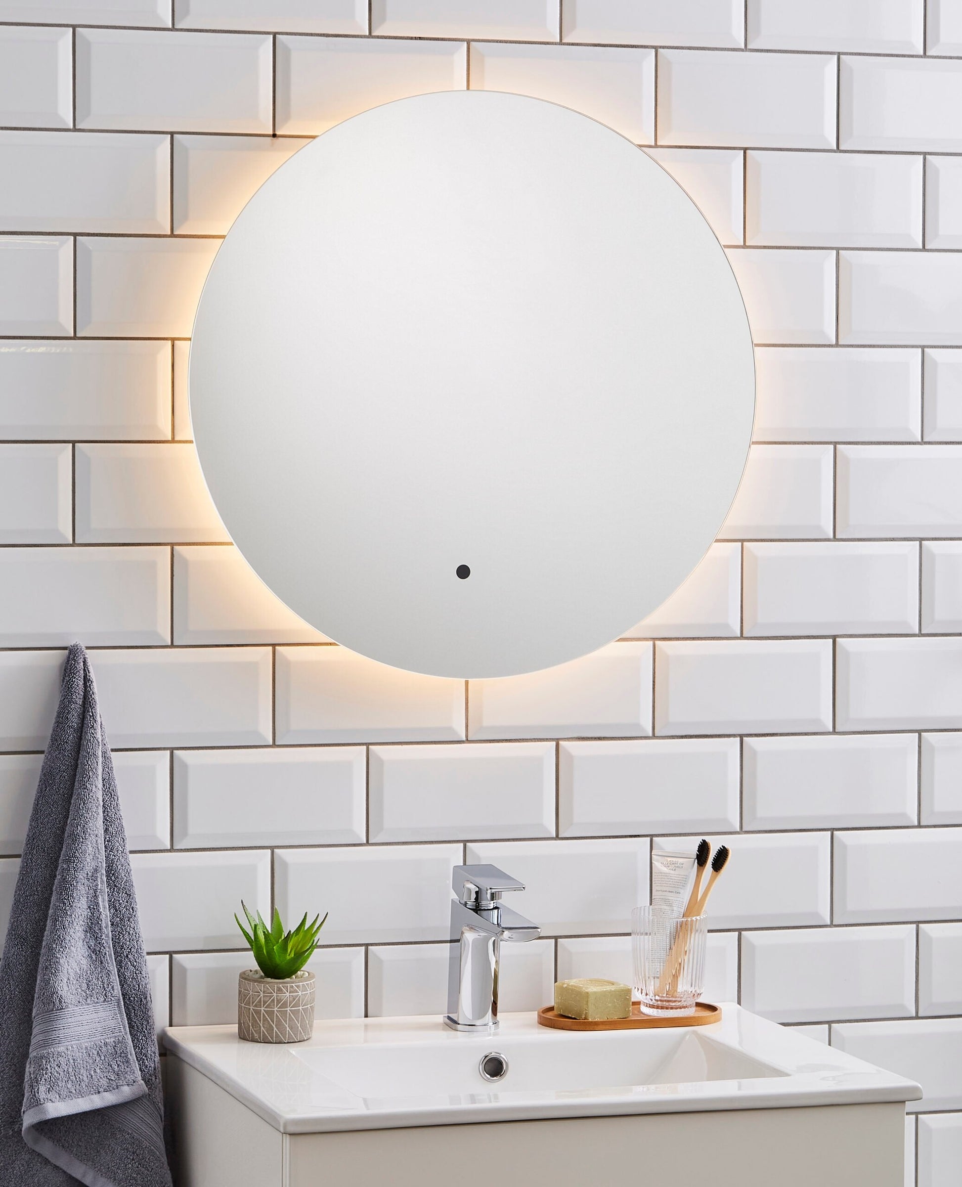 K-VIT Tucson 600mm Circular LED Mirror illuminated warm white, on white tiles 