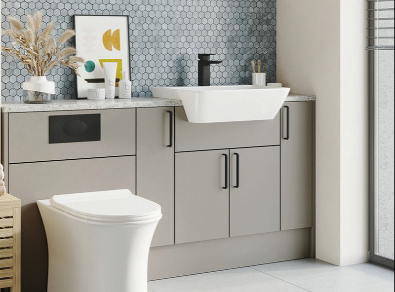 Bathroom with a toilet, sink, and decorative elements.
