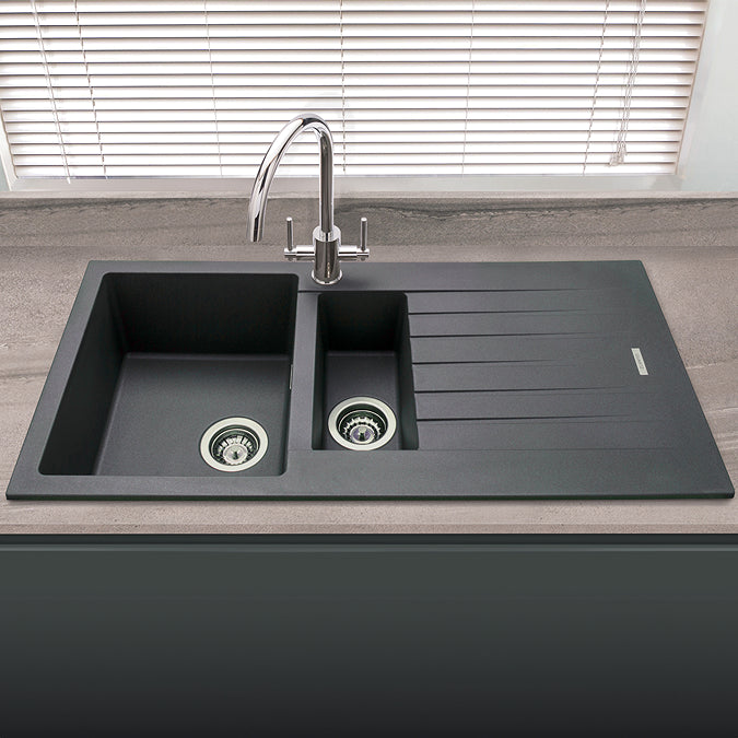Gray kitchen sink with faucet on a countertop